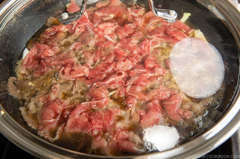 Cooking gyudon covered with a lid