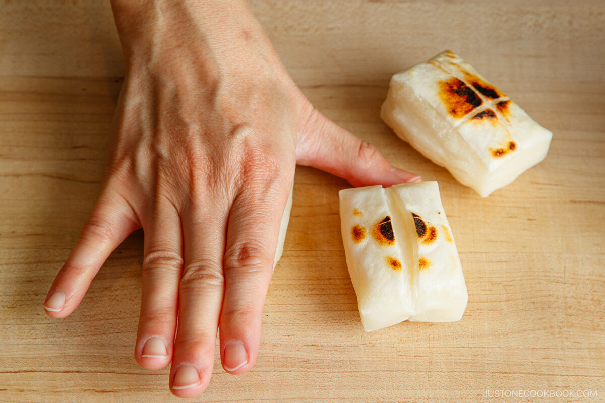 Gently smash the mochi with your hand.