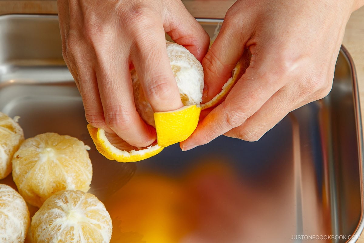 Peeling yuzu fruit.