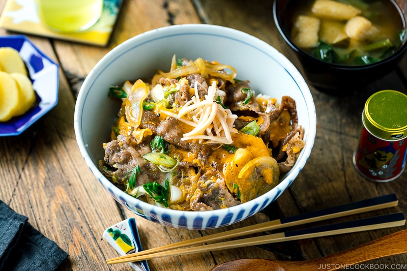 A Japanese donburi bowl containing Tanindon, which is simmered beef and egg over steamed rice.