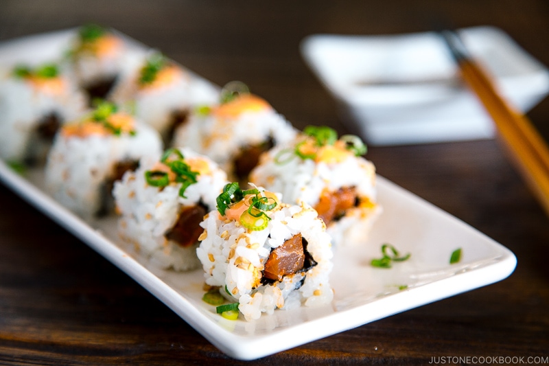 spicy tuna rolls presented on a white rectangular dish