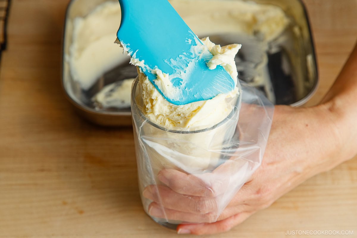 Adding the chilled cream cheese filling into the pastry bag.