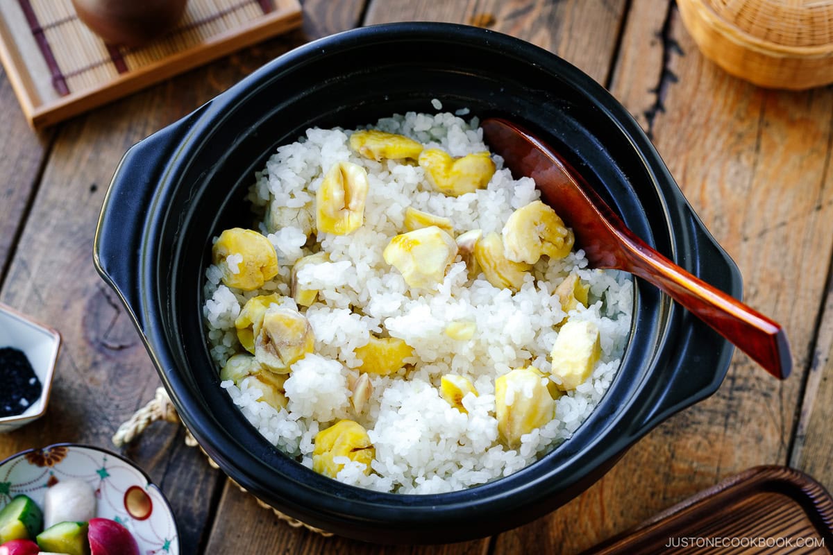 Chestnut rice being mixed together with a rice paddle.