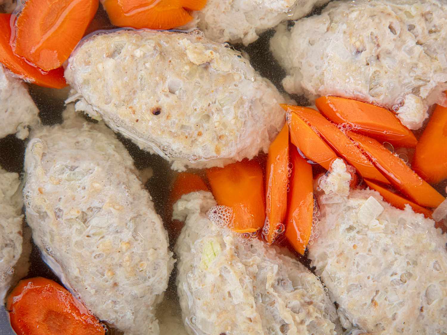 Overhead view of gefilte fish in pot