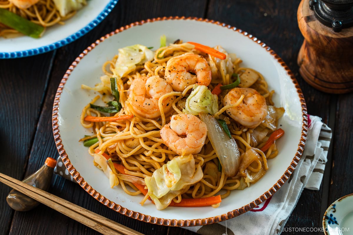 Round plates containing shrimp yakisoba.