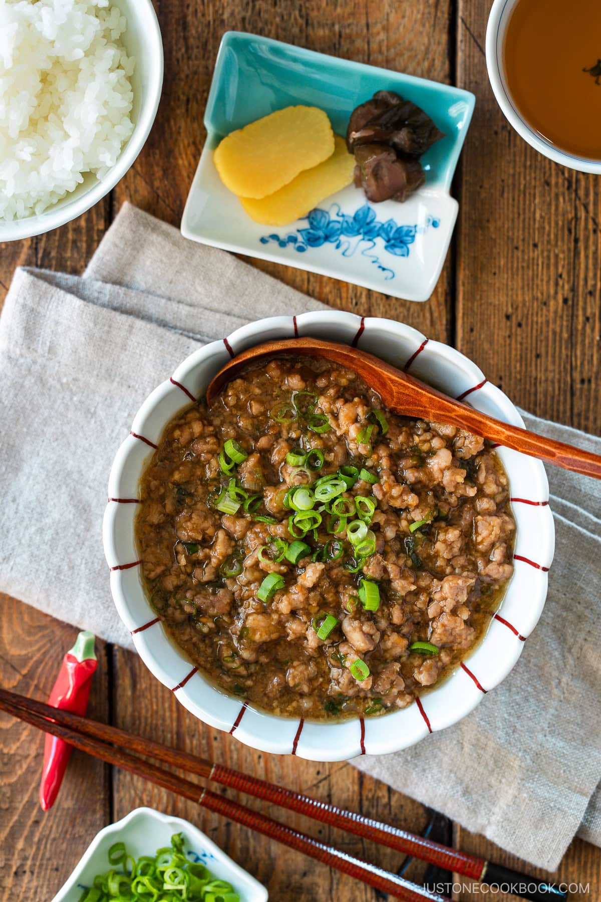 A round bowl containing Niku Miso, a savory Japanese ground pork dish seasoned with miso, mirin, and aromatics.