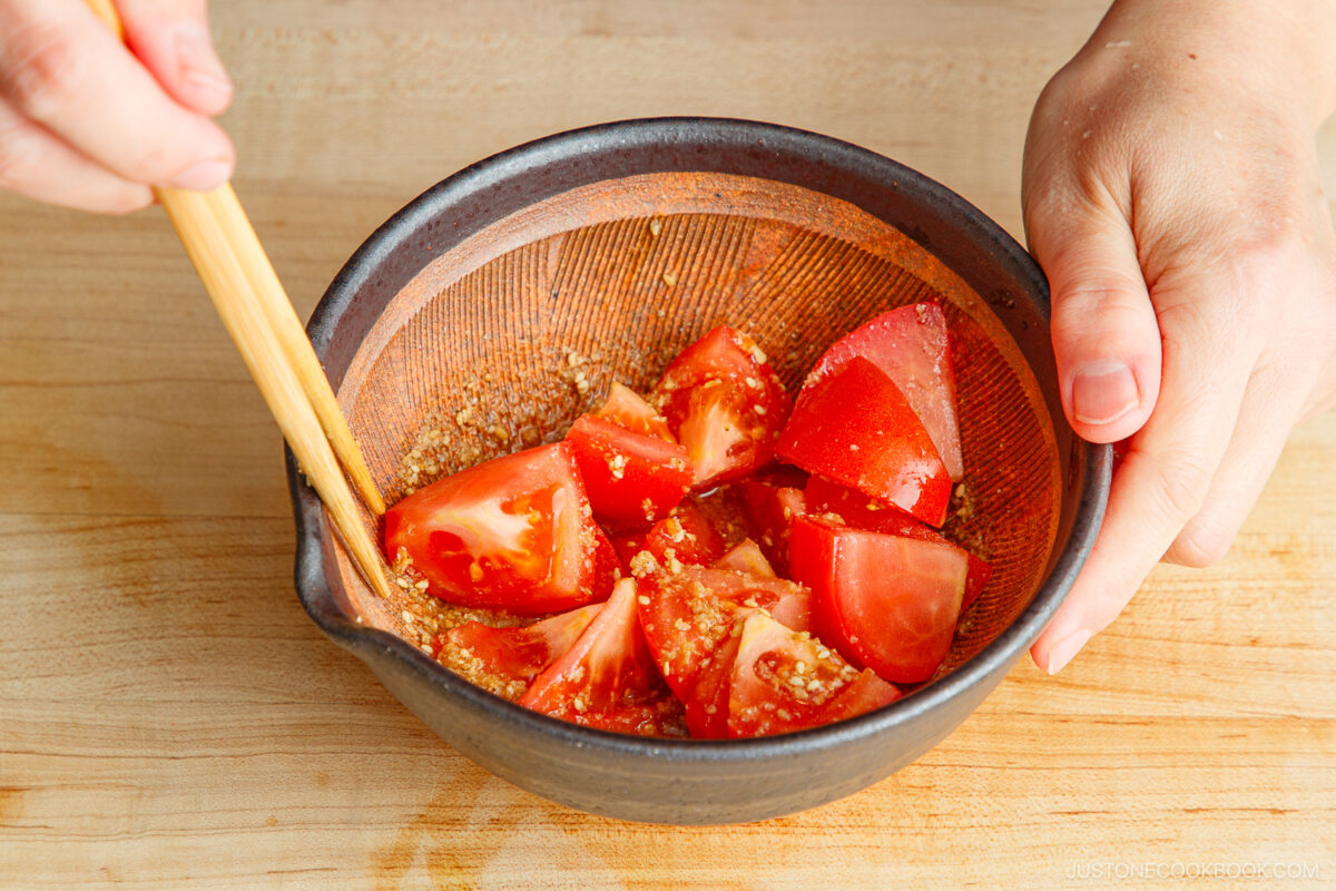 Dress the tomato pieces with the sesame ponzu dressing.