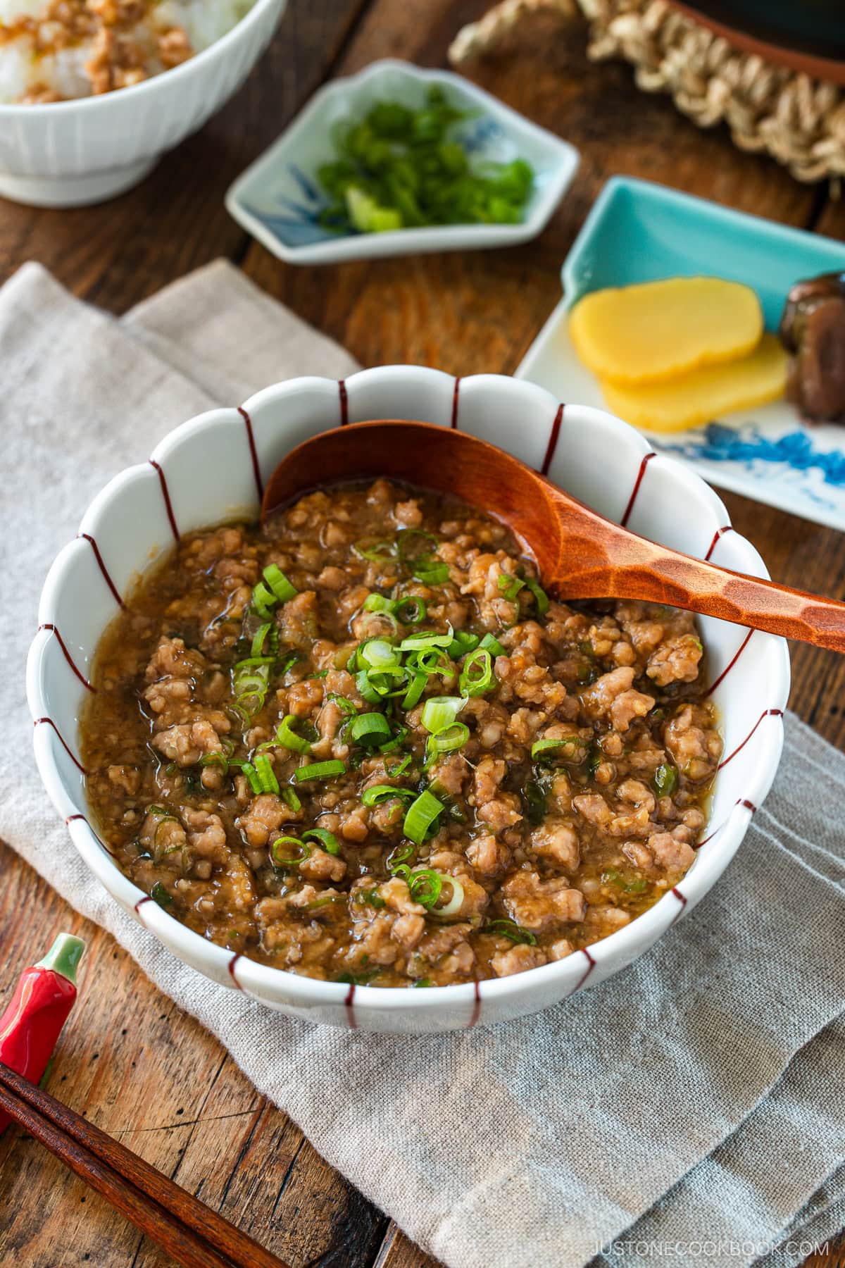 A round bowl containing Niku Miso, a savory Japanese ground pork dish seasoned with miso, mirin, and aromatics.