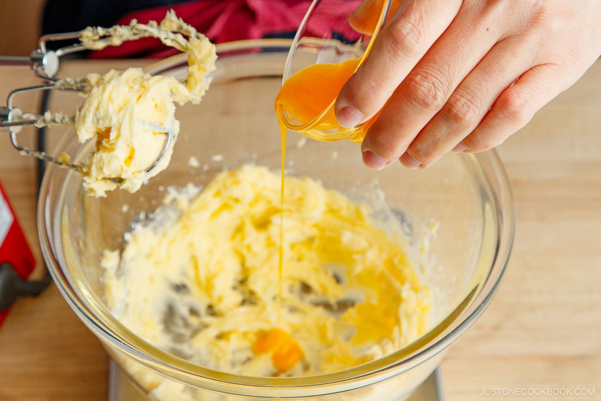 Adding egg yolk to the dough.