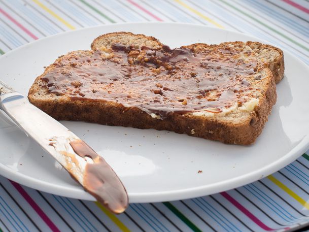 Yeast extract, or Marmite, spread on a piece of bread with butter. 