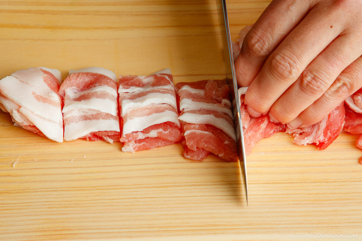 Cutting the pork belly into 2-inch pieces.