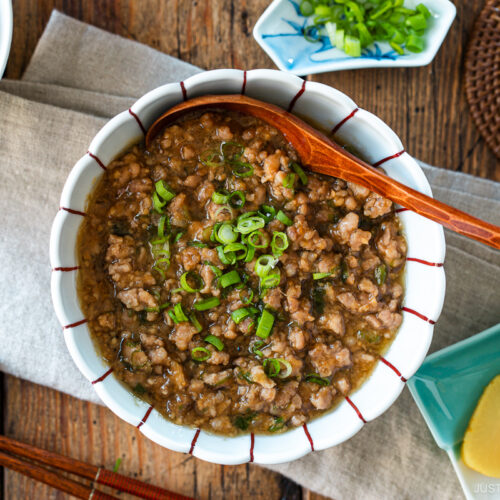 A round bowl containing Niku Miso, a savory Japanese ground pork dish seasoned with miso, mirin, and aromatics.