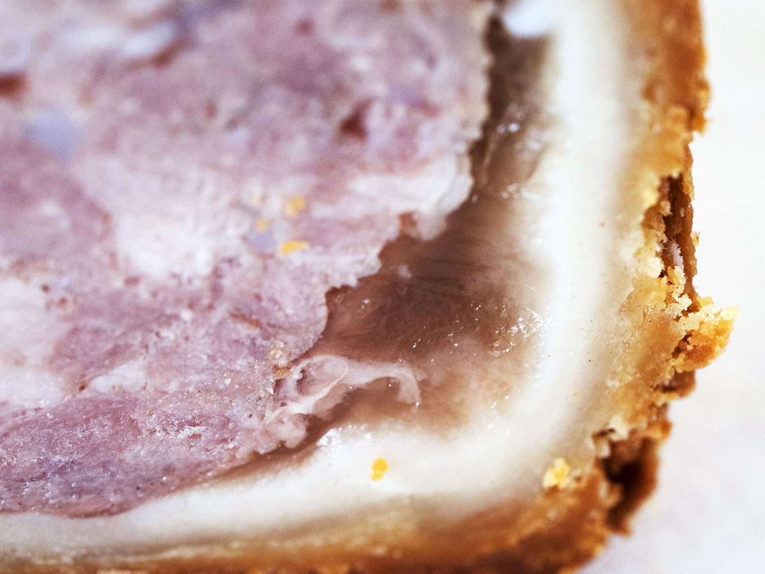 A close-up of the jelly layer inside a Melton Mowbray pork pie.