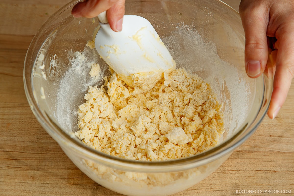 Adding flour to the dough.