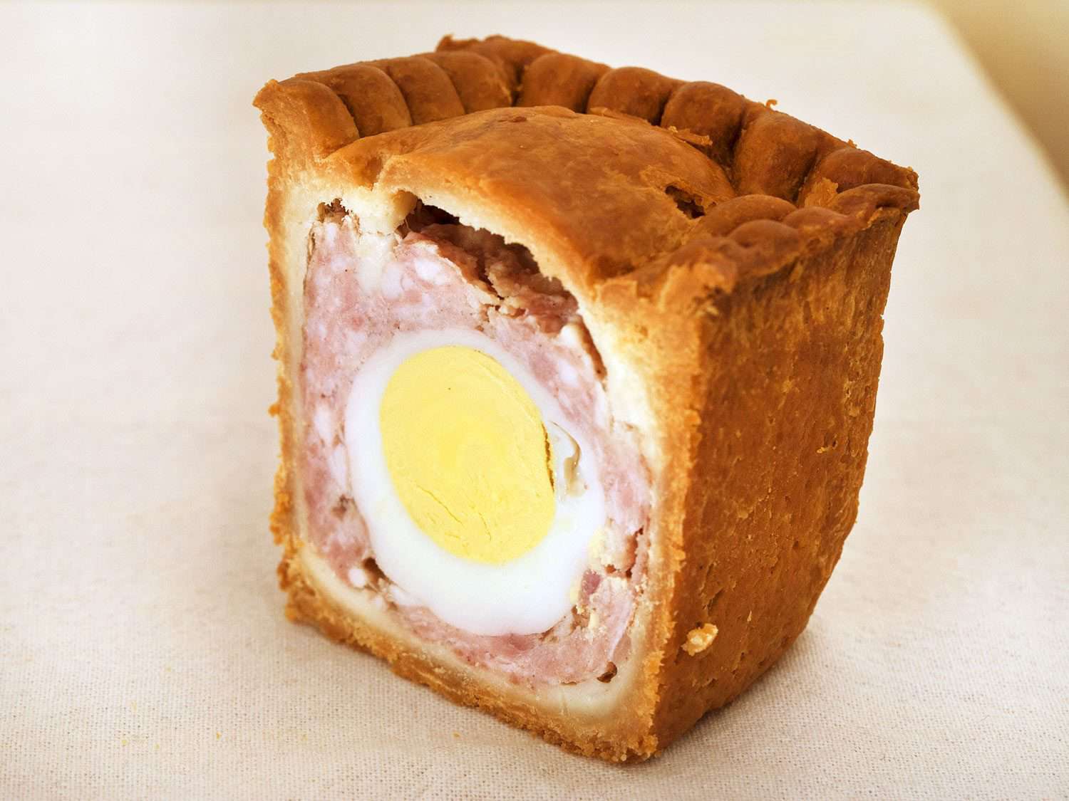 Interior of a gala pie, showing the meat filling surrounding the hard-boiled egg at the center