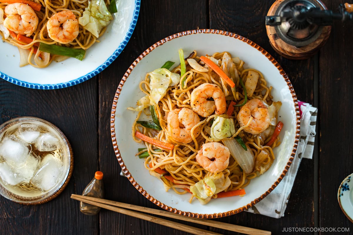 Round plates containing shrimp yakisoba.