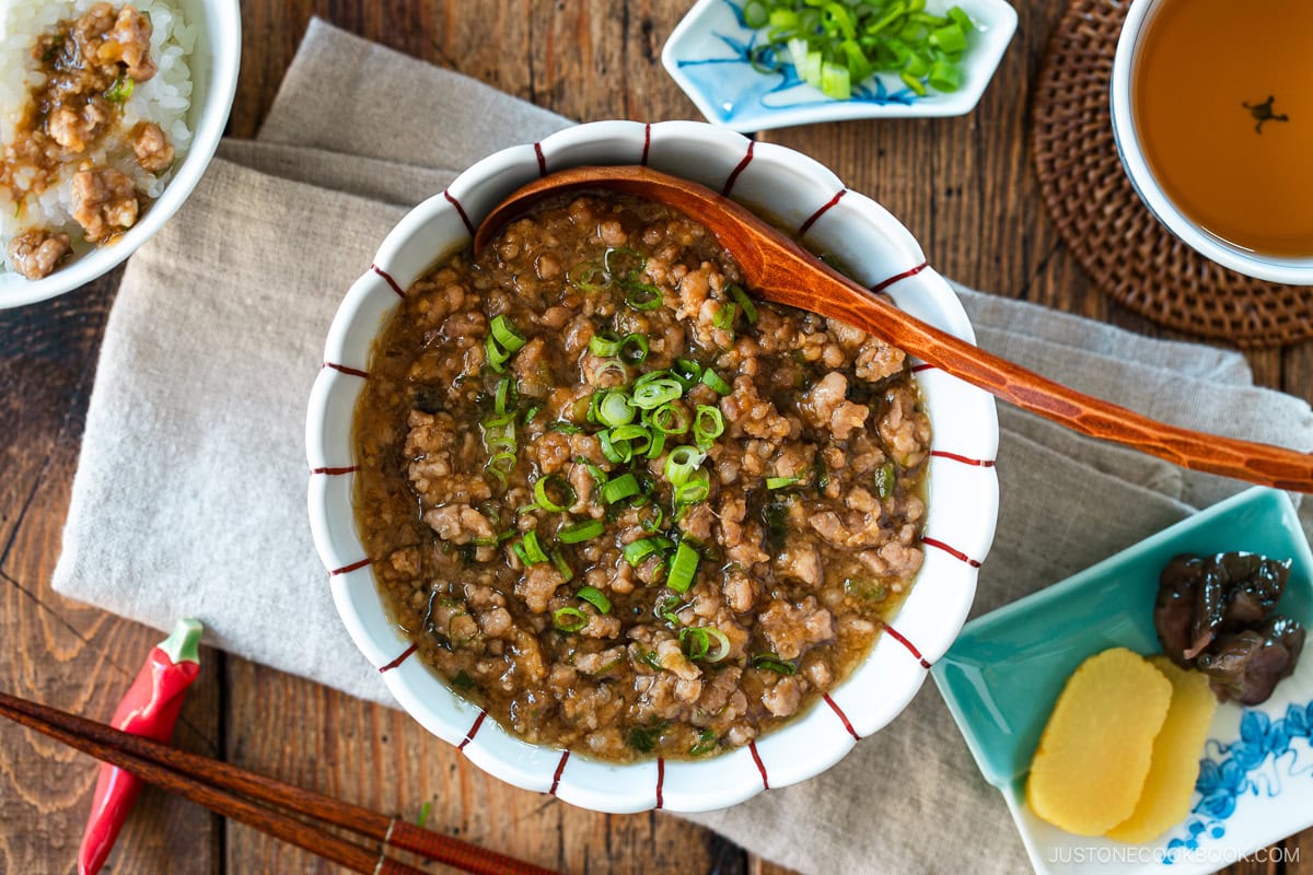 A round bowl containing Niku Miso, a savory Japanese ground pork dish seasoned with miso, mirin, and aromatics.