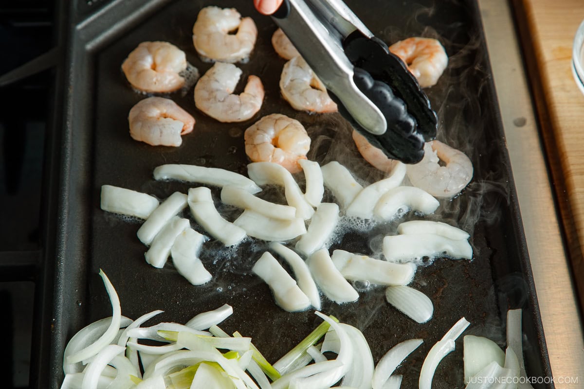 Stir fry the vegetables and seafood on the griddle.