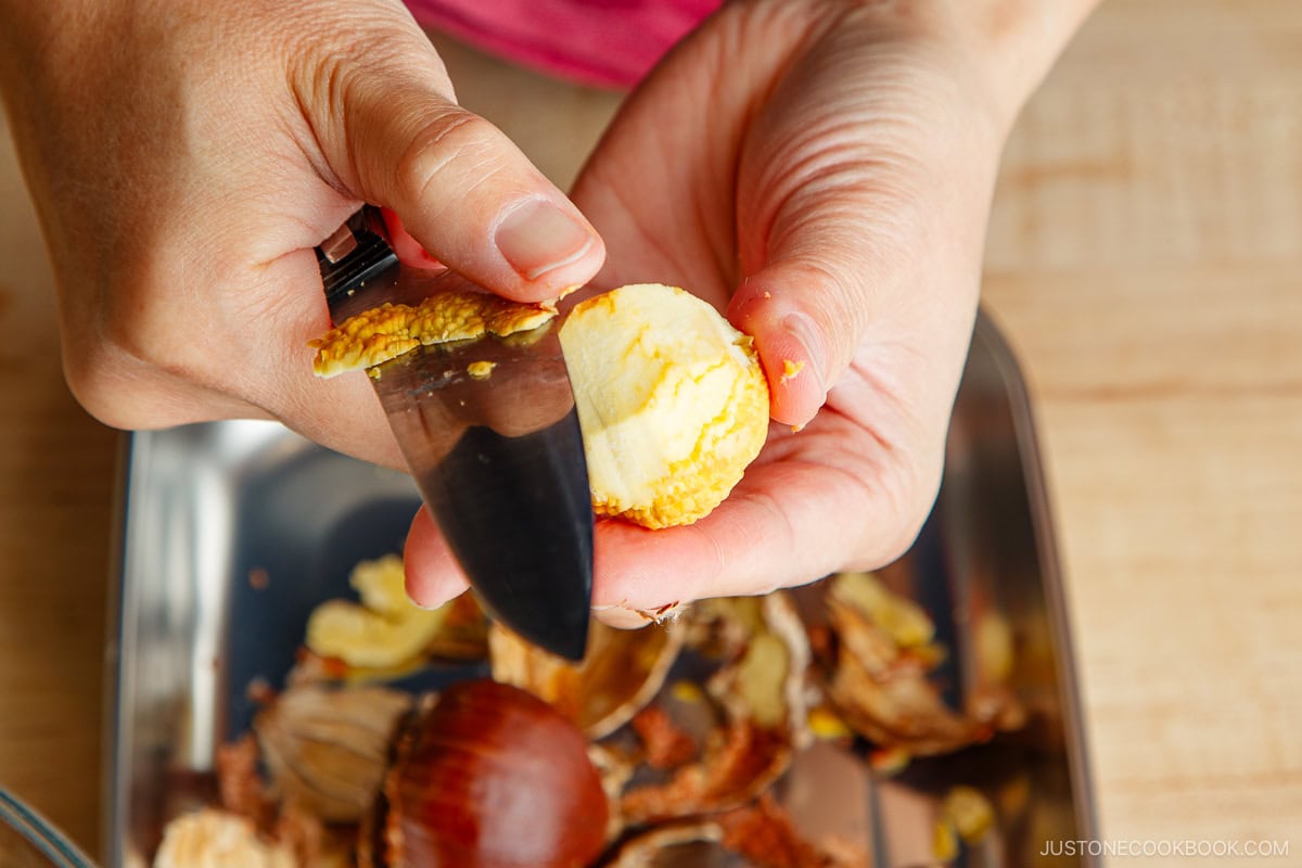 Peeling papery inner skins.
