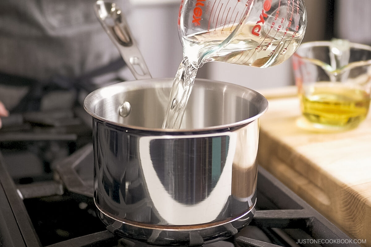 Pouring sake into the pot.