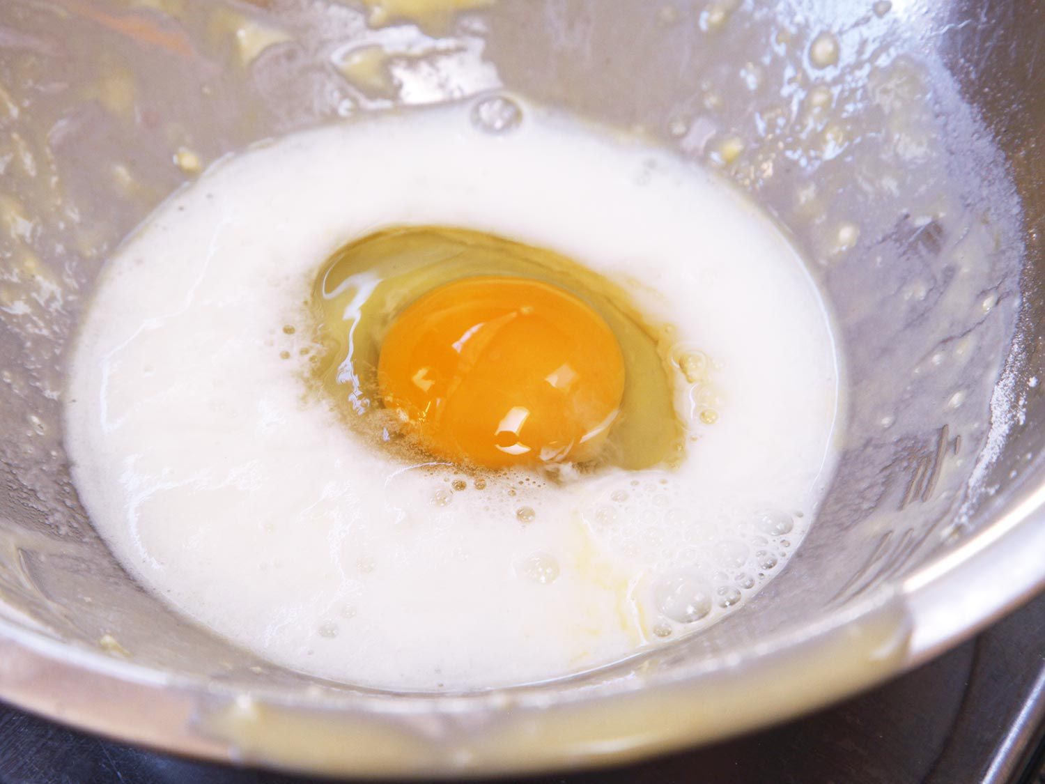 Egg and milk in mixing bowl