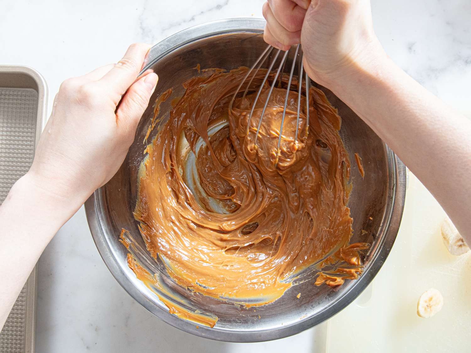Whisking dulce de leche in a bowl.
