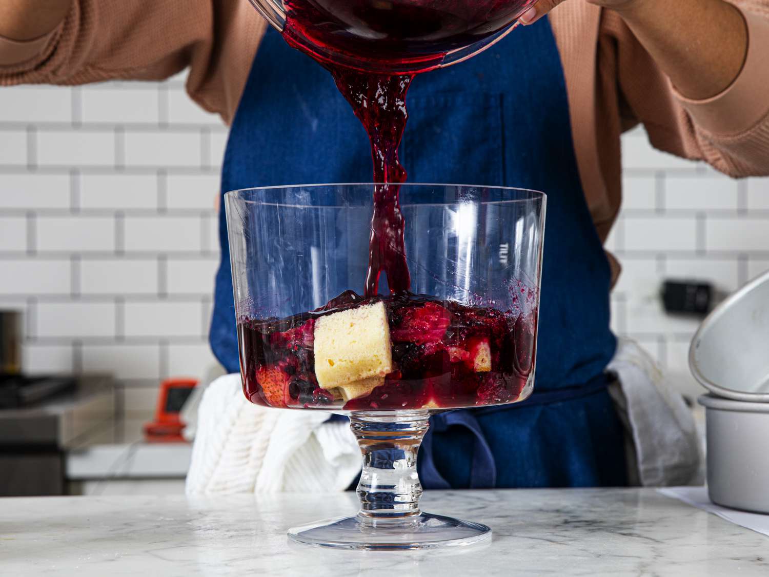 Side view of pouring jelly into trifle 