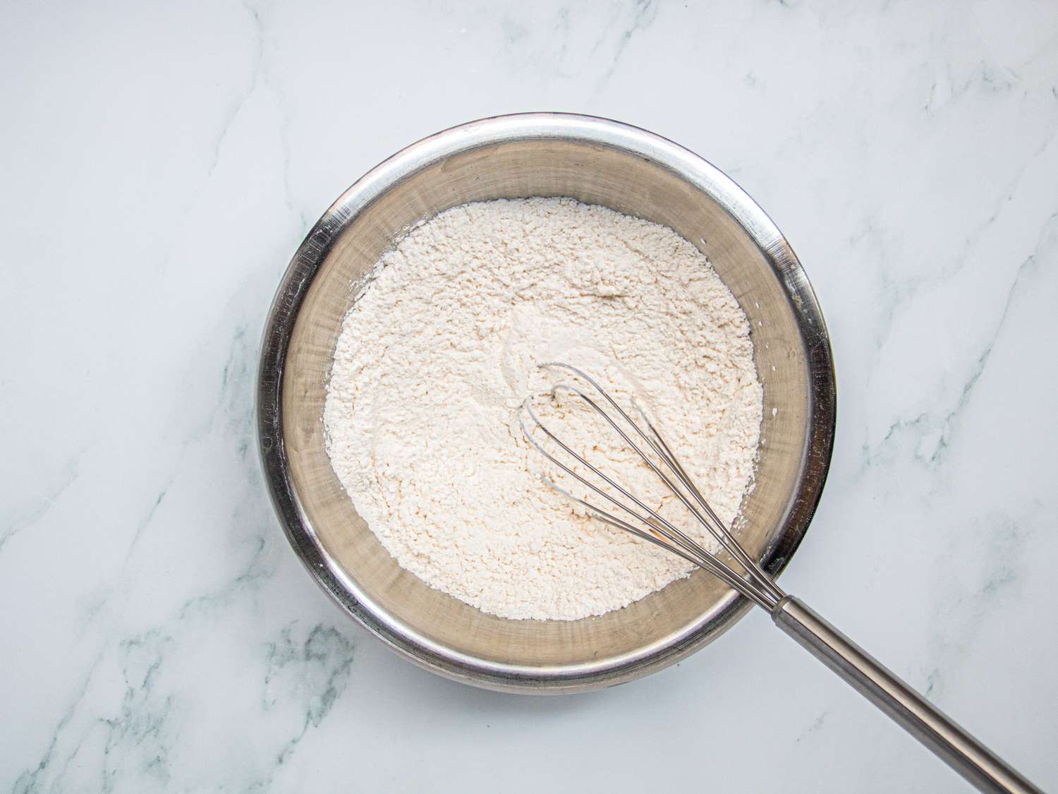 OVerhead view of whisking dry ingredients together