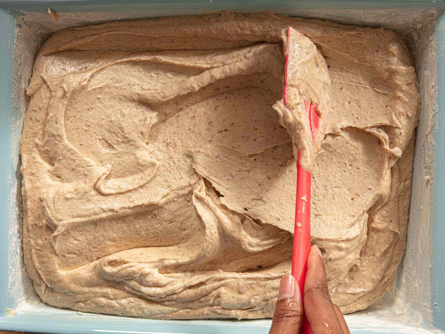 Overhead view of put cake mixture into pan