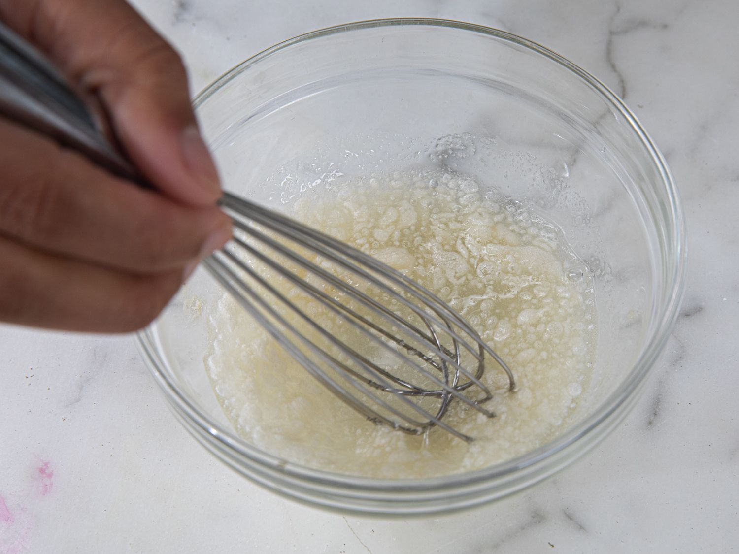 Whisking gelatin in a small glass bowl