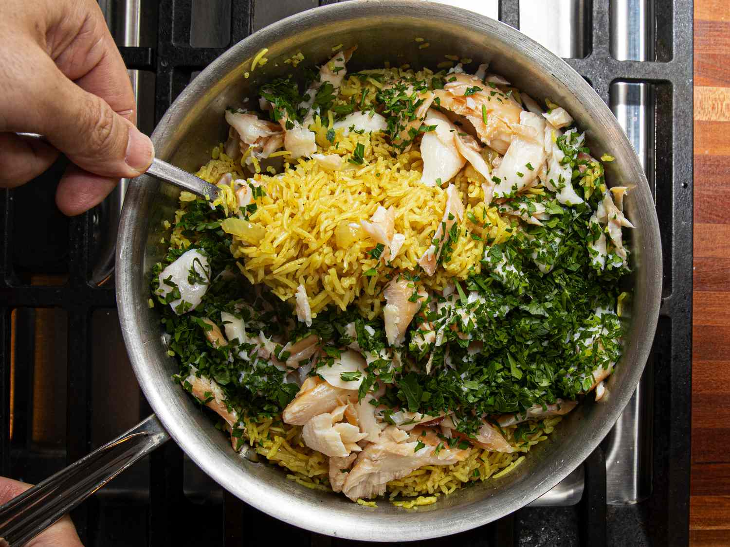 Overhead view of folding ingredients in pot
