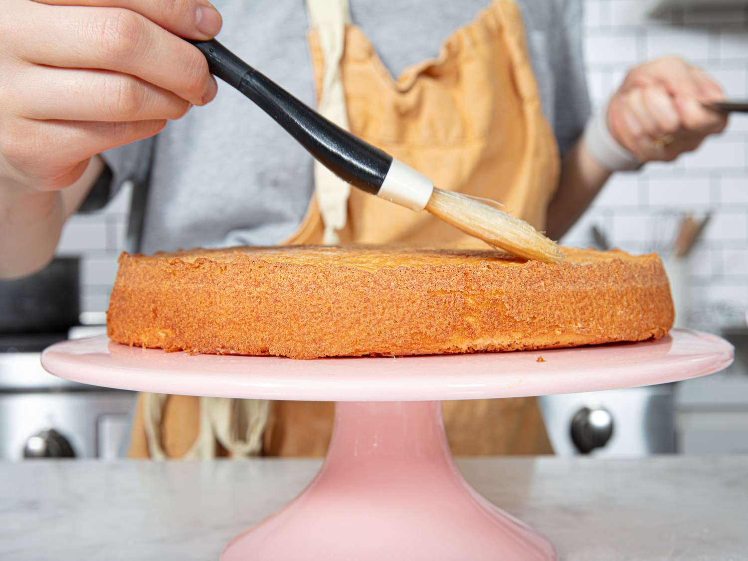 Brushing cake with simple syrup