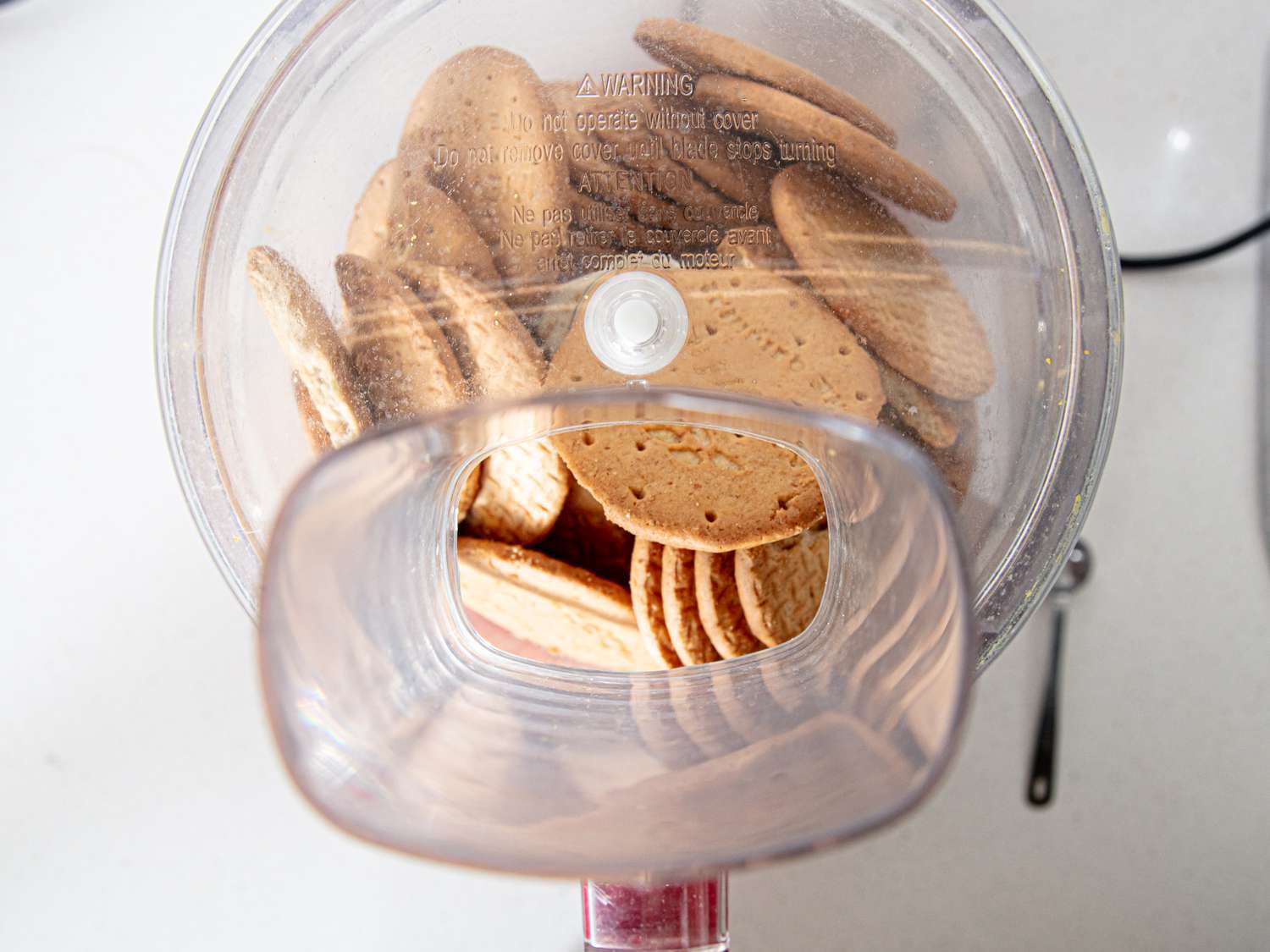 Digestive biscuits in the bowl of a food processor.