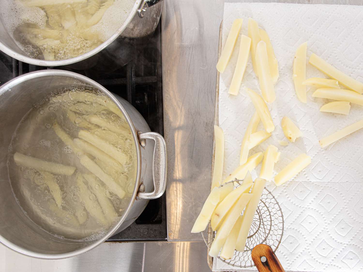 Overhead view of transferring boiling potatoes 