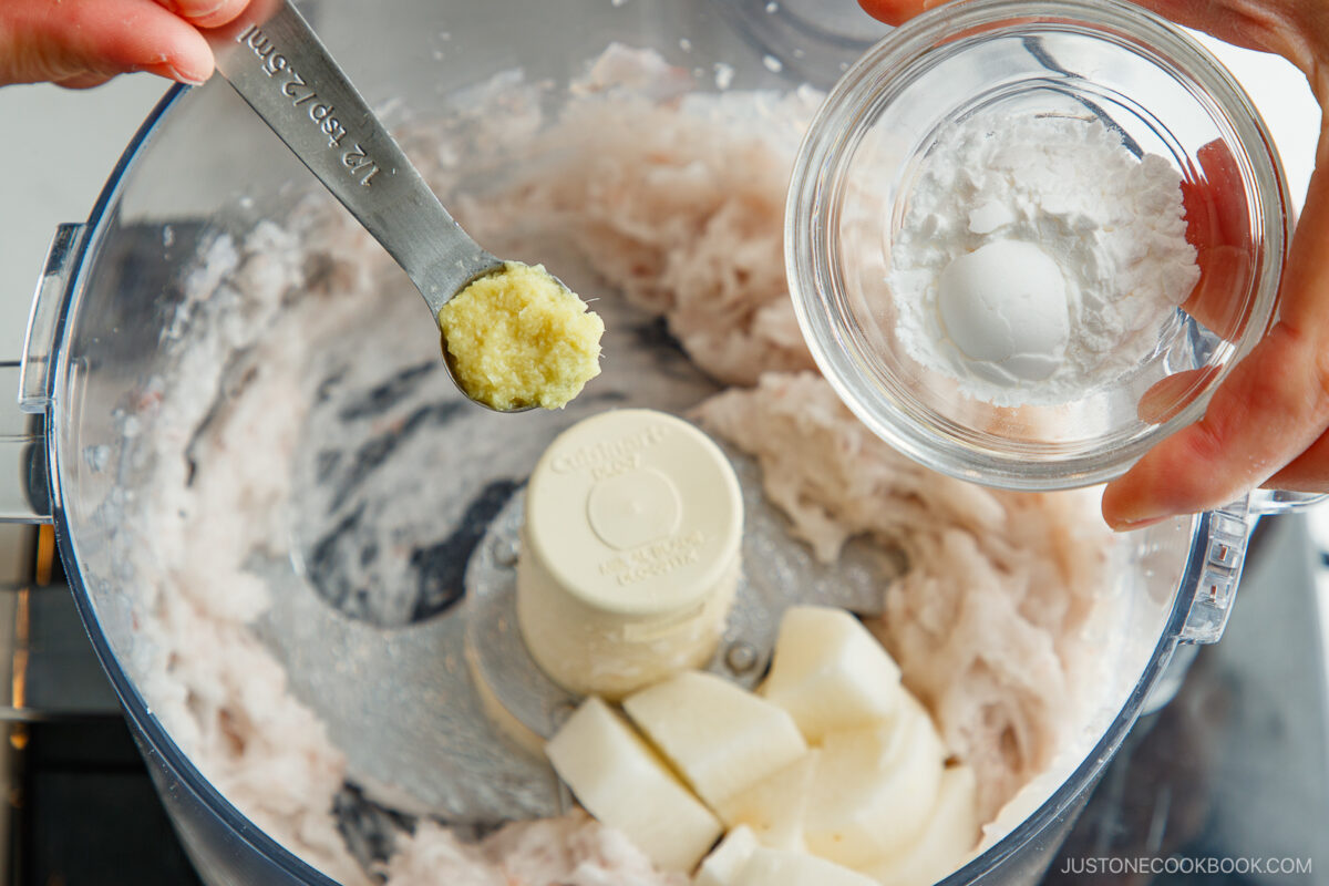 Adding the grated ginger, nagaimo, and potato starch to the shrimp paste.
