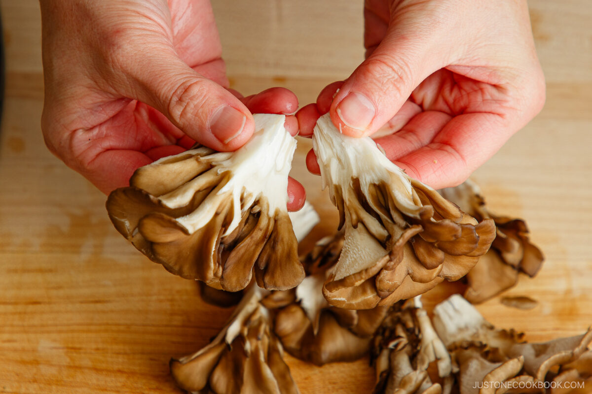 Separate the maitake mushrooms into small pieces.