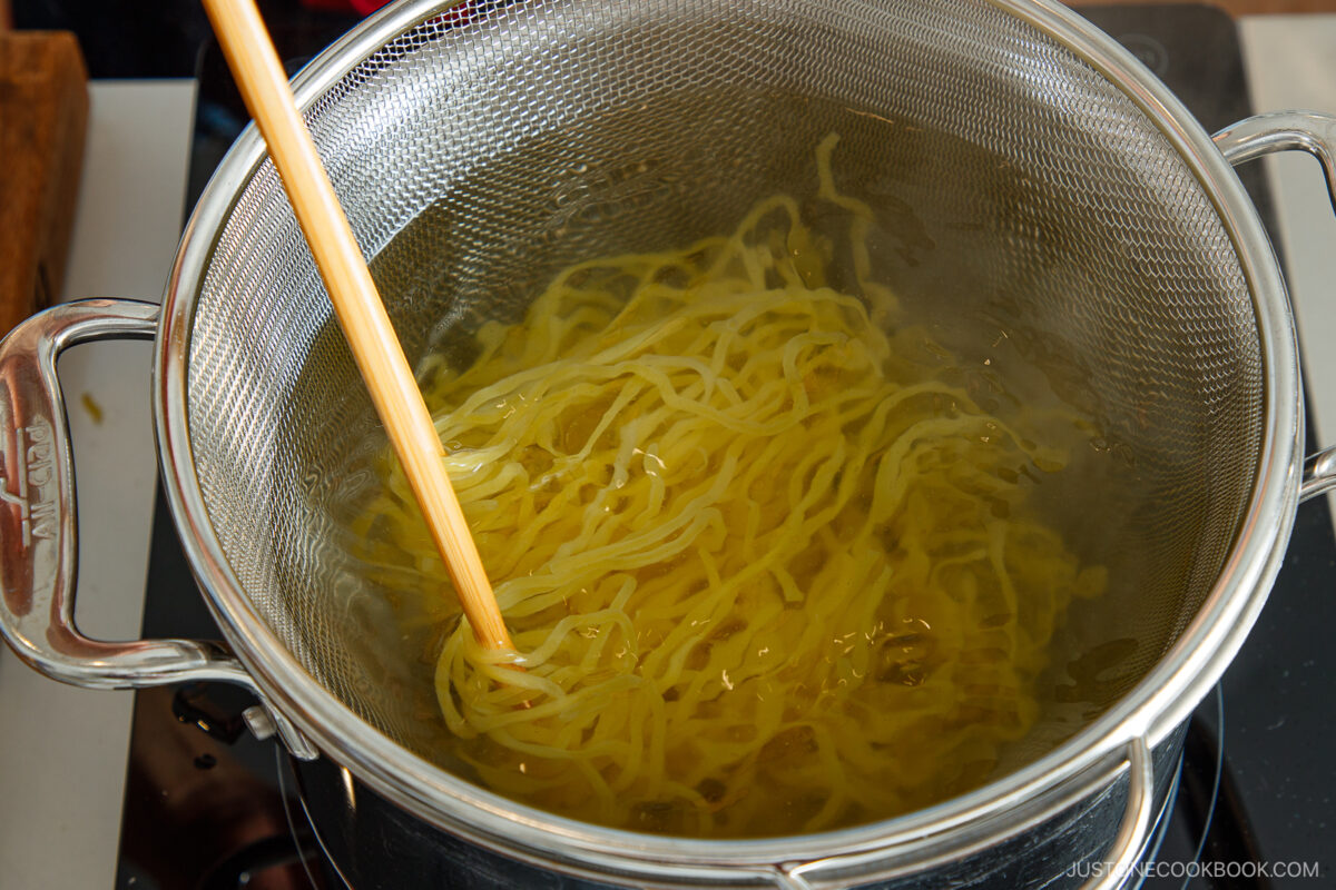 Cooking ramen noodles in the boiling water.