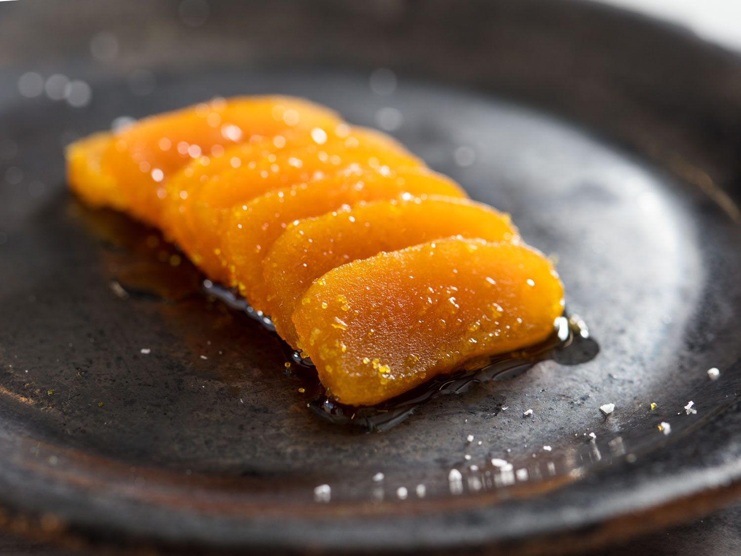 Slice bottarga dressed with olive oil, lemon, and salt.