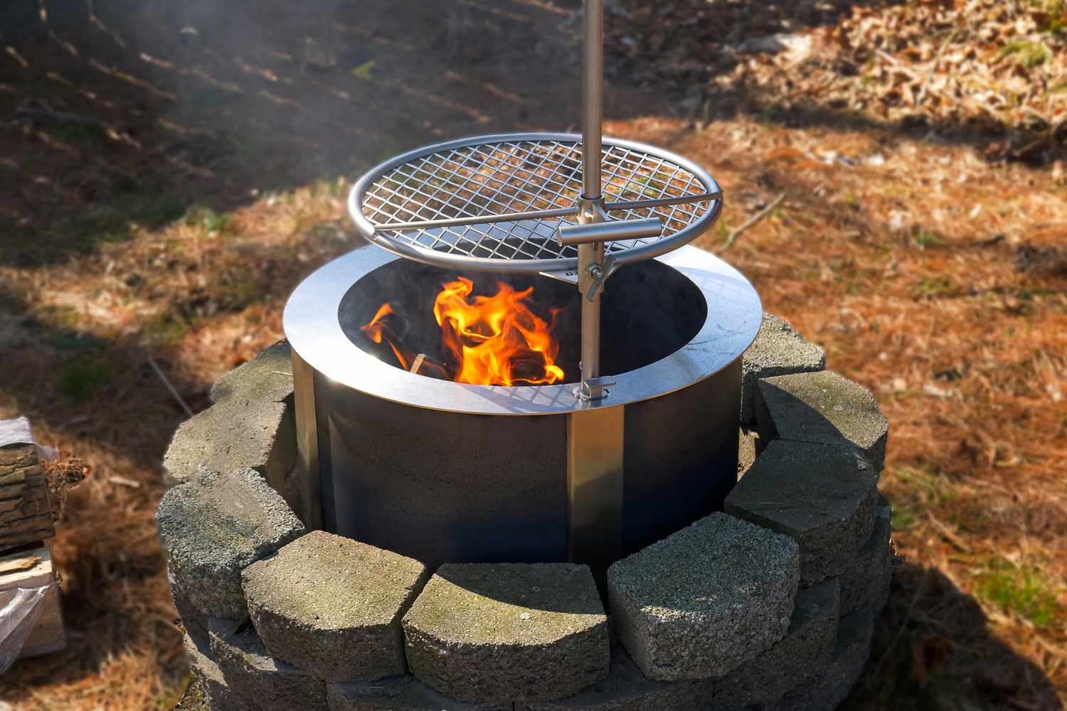 Outdoor fire pit with a grid cooking grate above the fire
