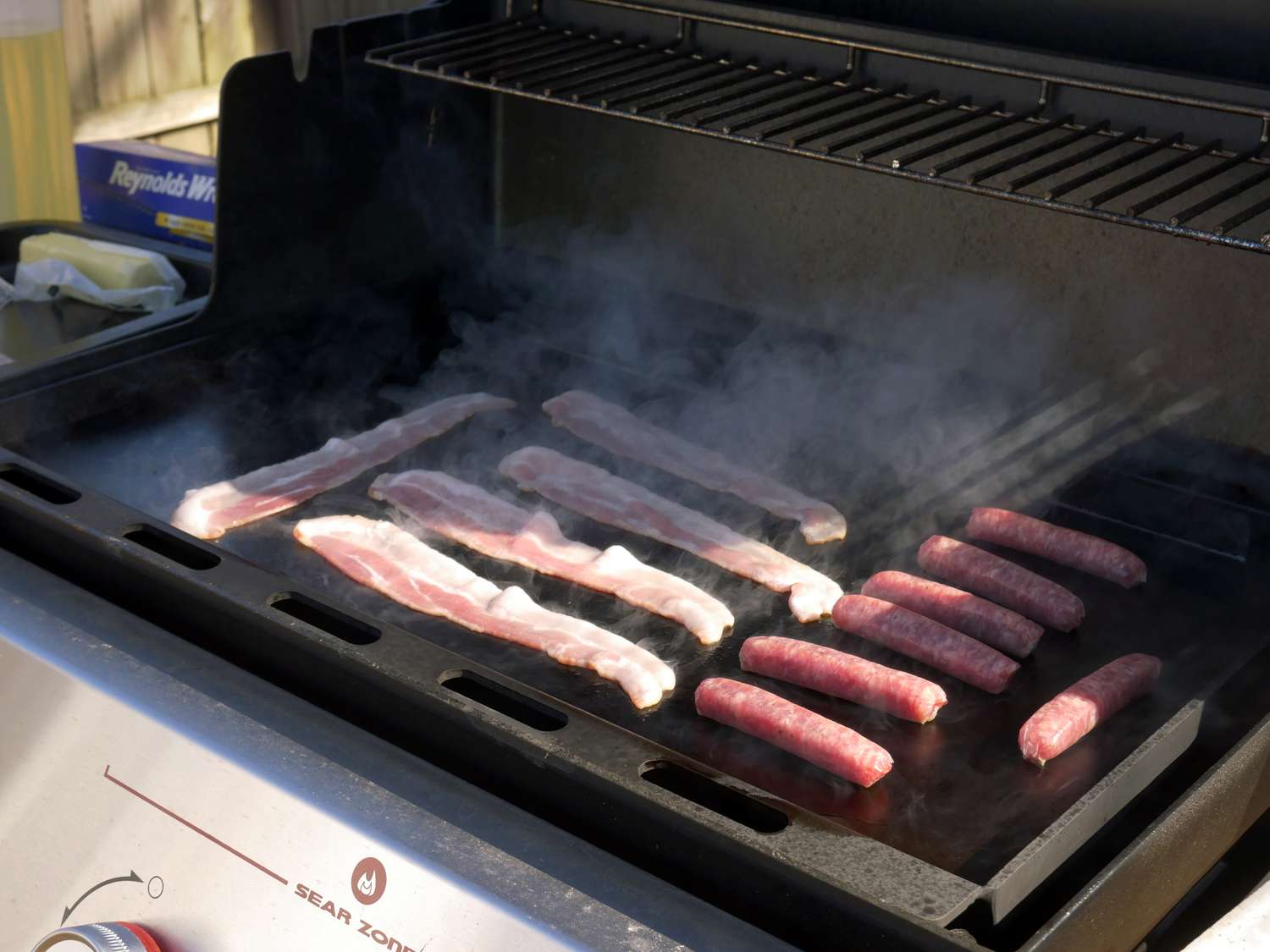 cooking bacon and breakfast sausage on the weber griddle insert
