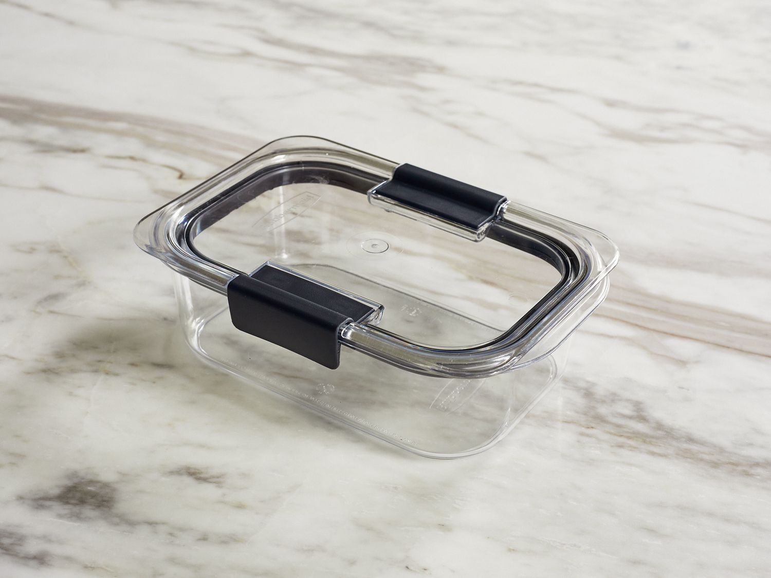 a plastic storage container sitting on a marble surface