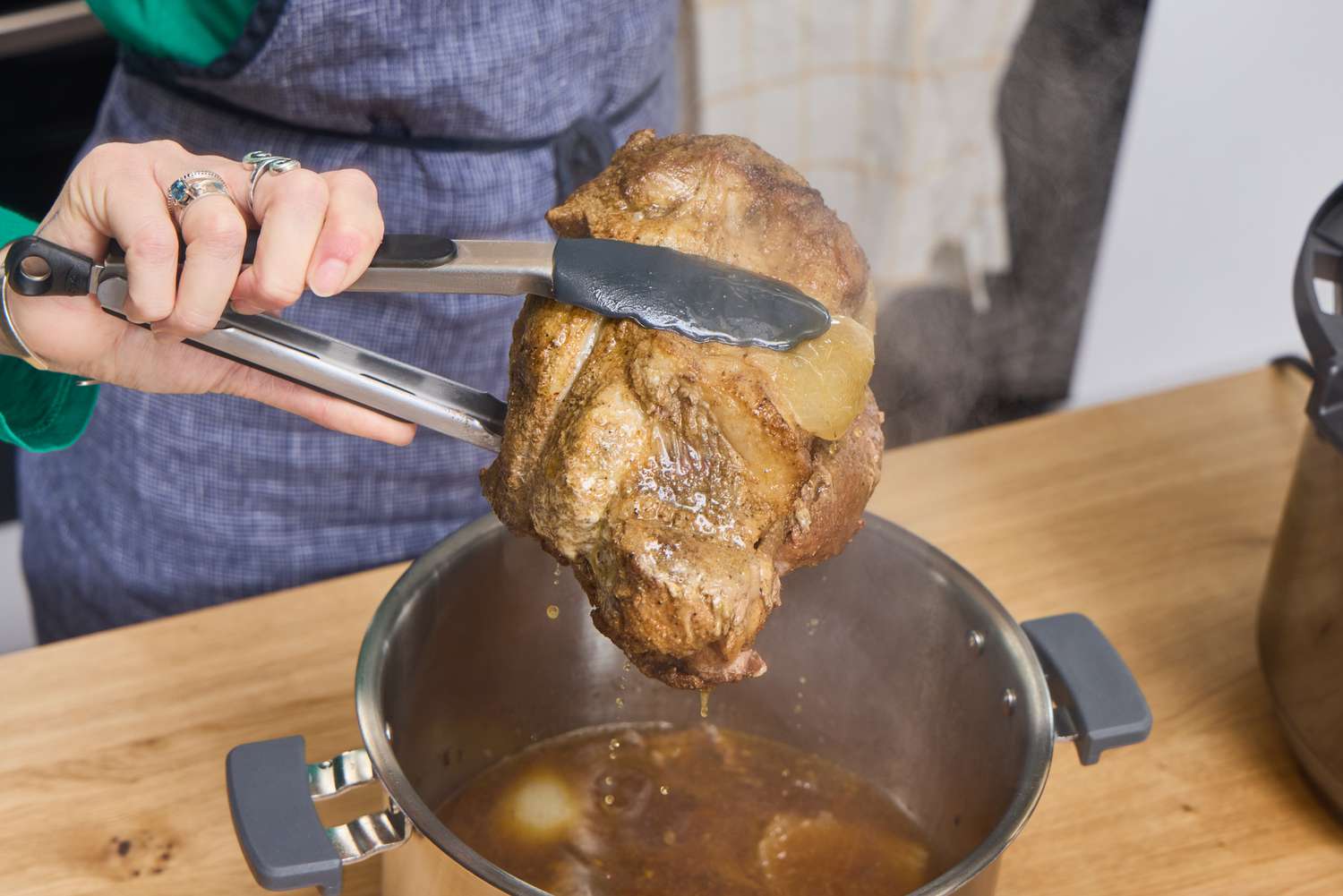 A person holds chicken boiled in Instant Pot Duo Plus 6-Quart 9-in-1 Pressure Cooker