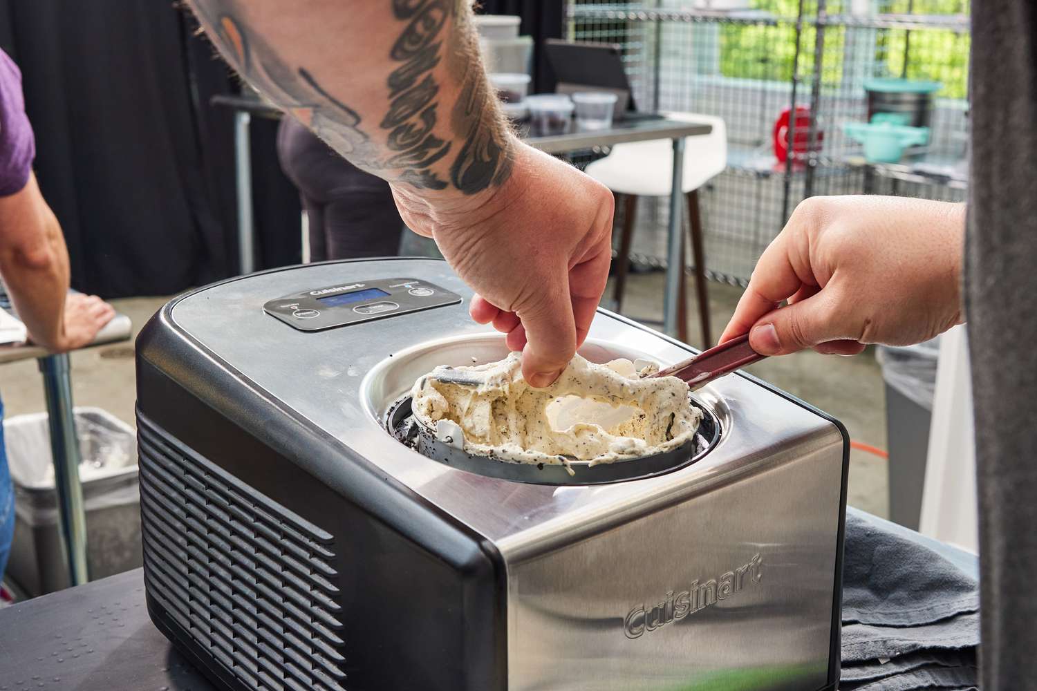 Hands removing Cuisinart ICE-100 Compressor Ice Cream and Gelato Maker paddle after churning ice cream