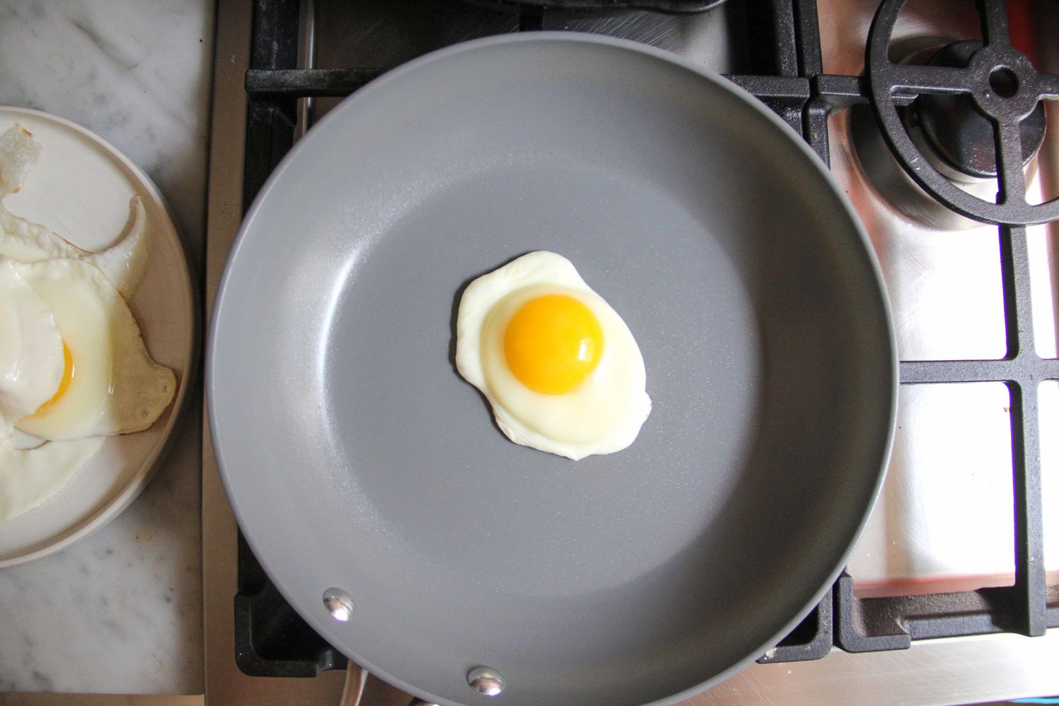 An egg cooking in the Caraway Nonstick Ceramic Frying Pan