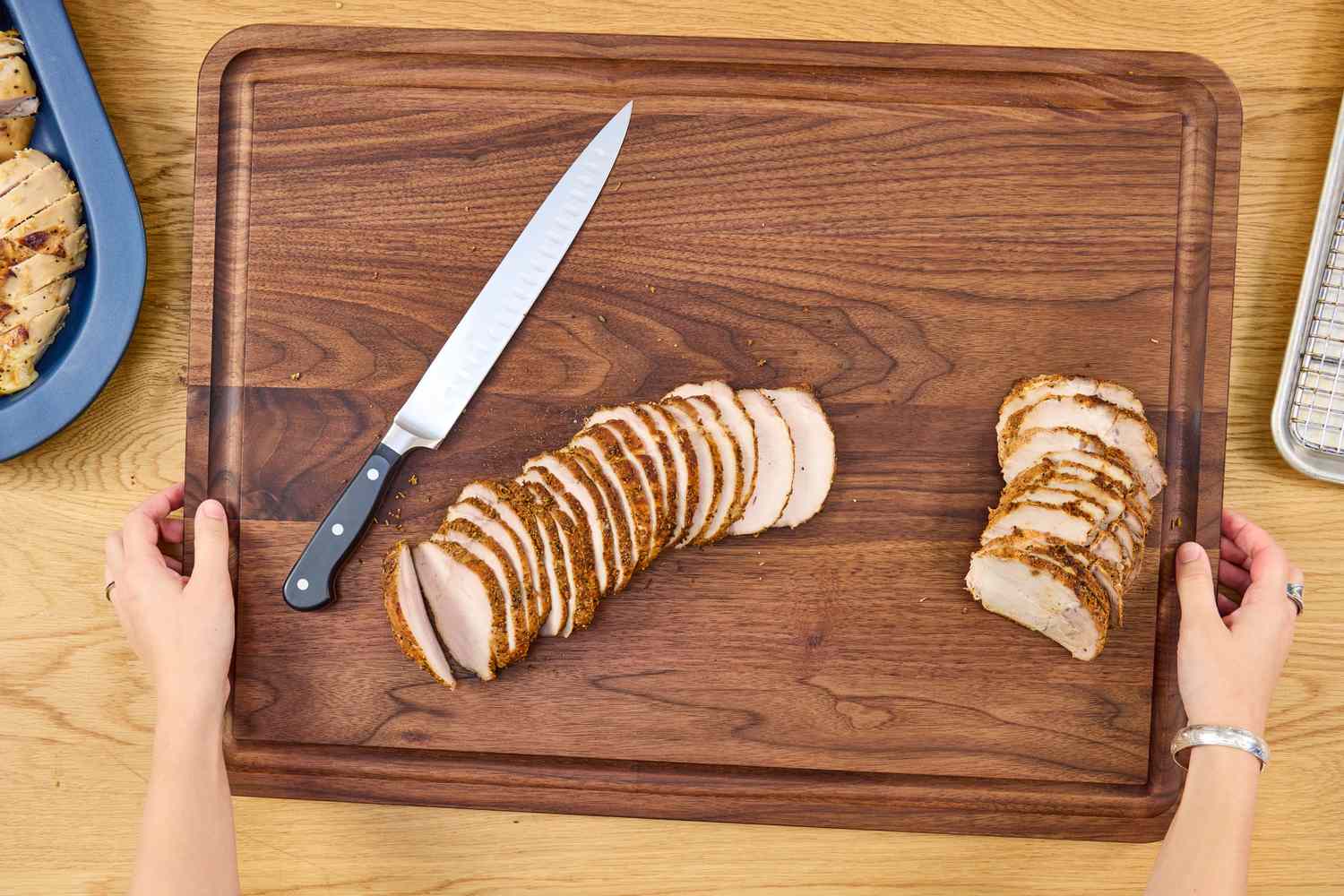 Sliced roasted meat on a Virginia Boys Kitchens Walnut Wood Cutting Board