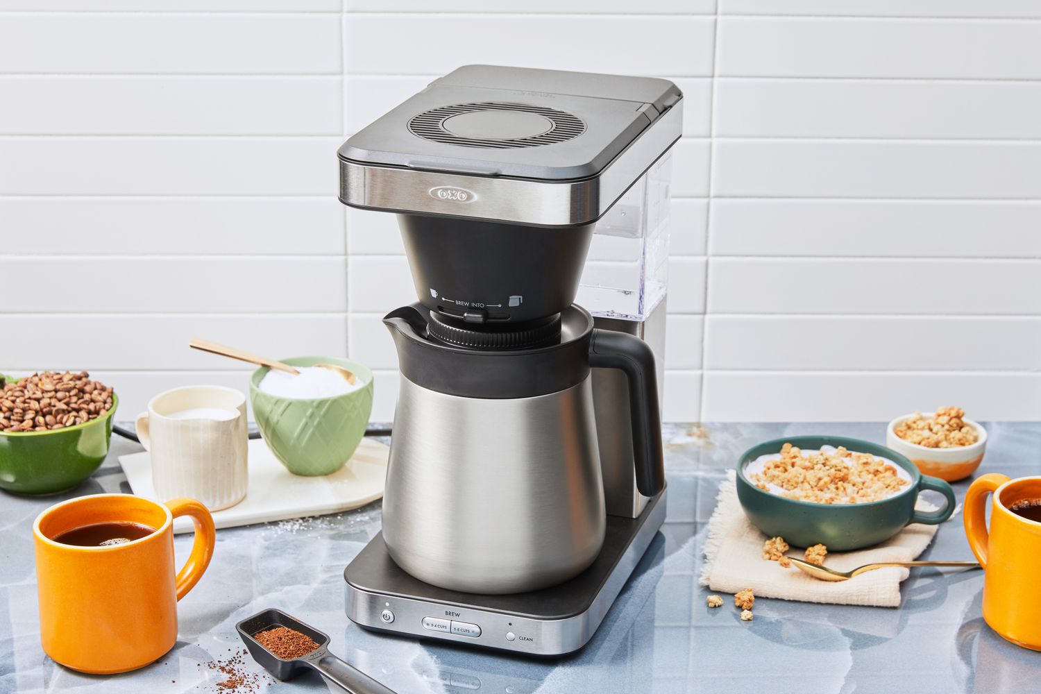 OXO Brew 8-Cup Coffee Maker displayed on a kitchen counter with breakfast food and mug of coffee