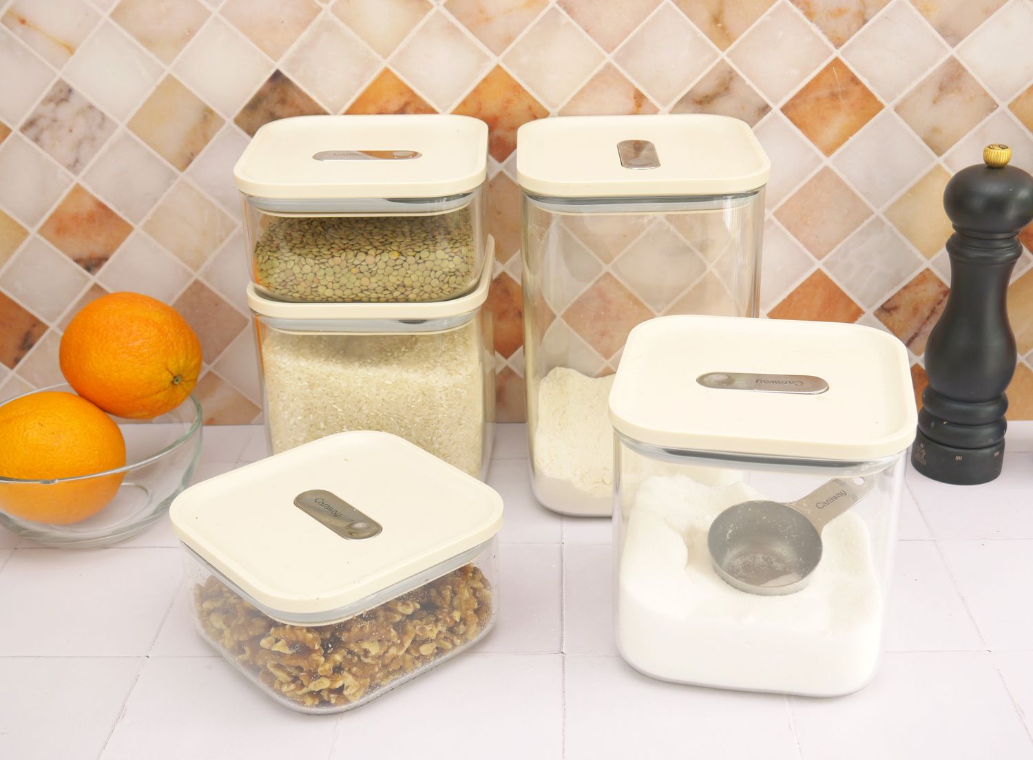 caraway dry food storage containers on a white tile surface