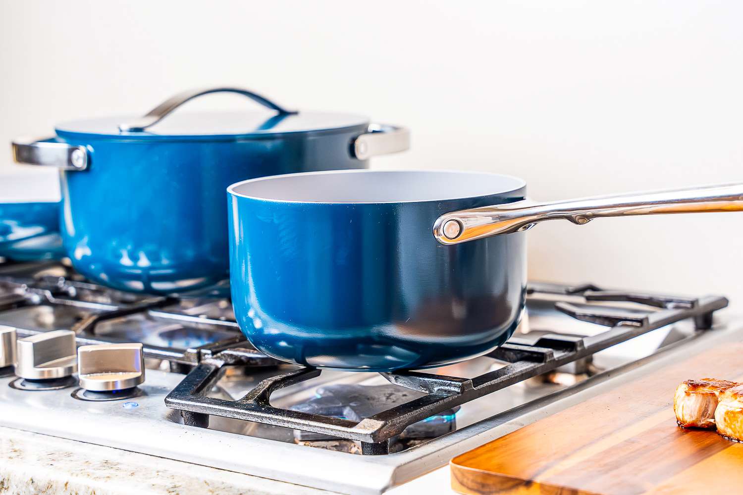 Two pots from the Caraway Cookware Set on a stove