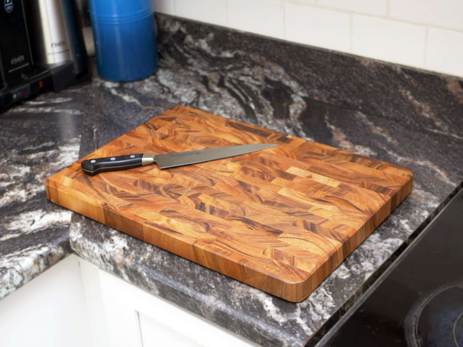 ironwood acacia board on a countertop with a chef's knife