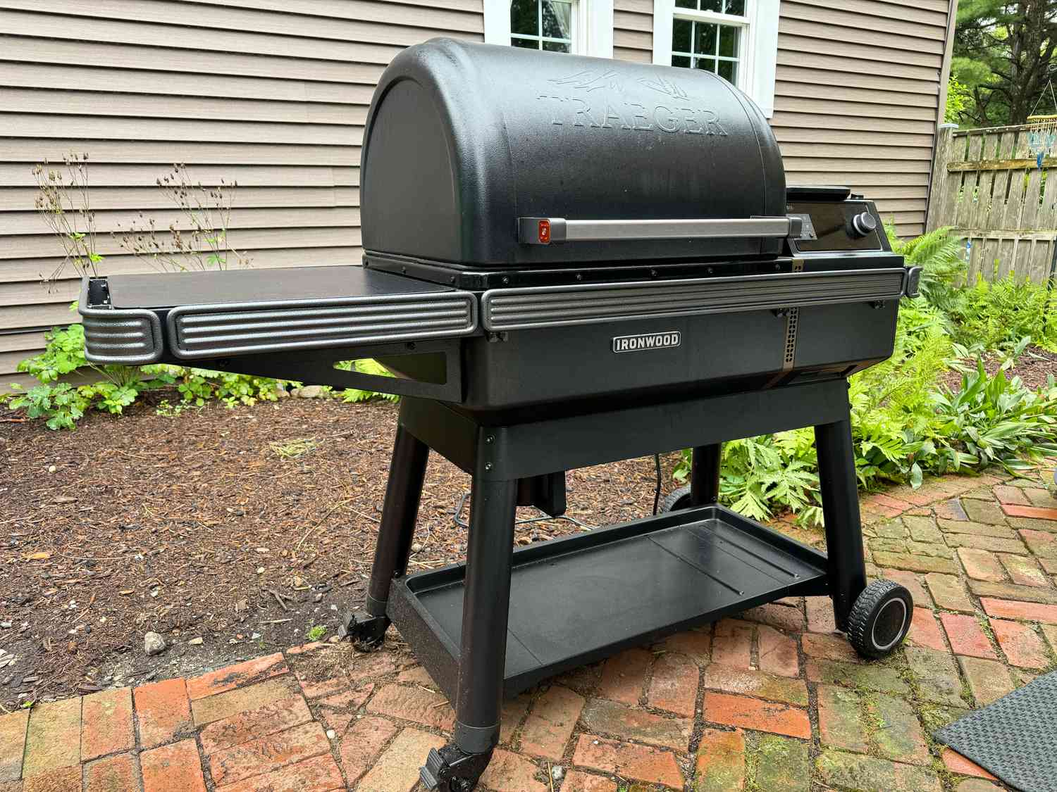 The Traeger Ironwood pellet grill on a brick patio.